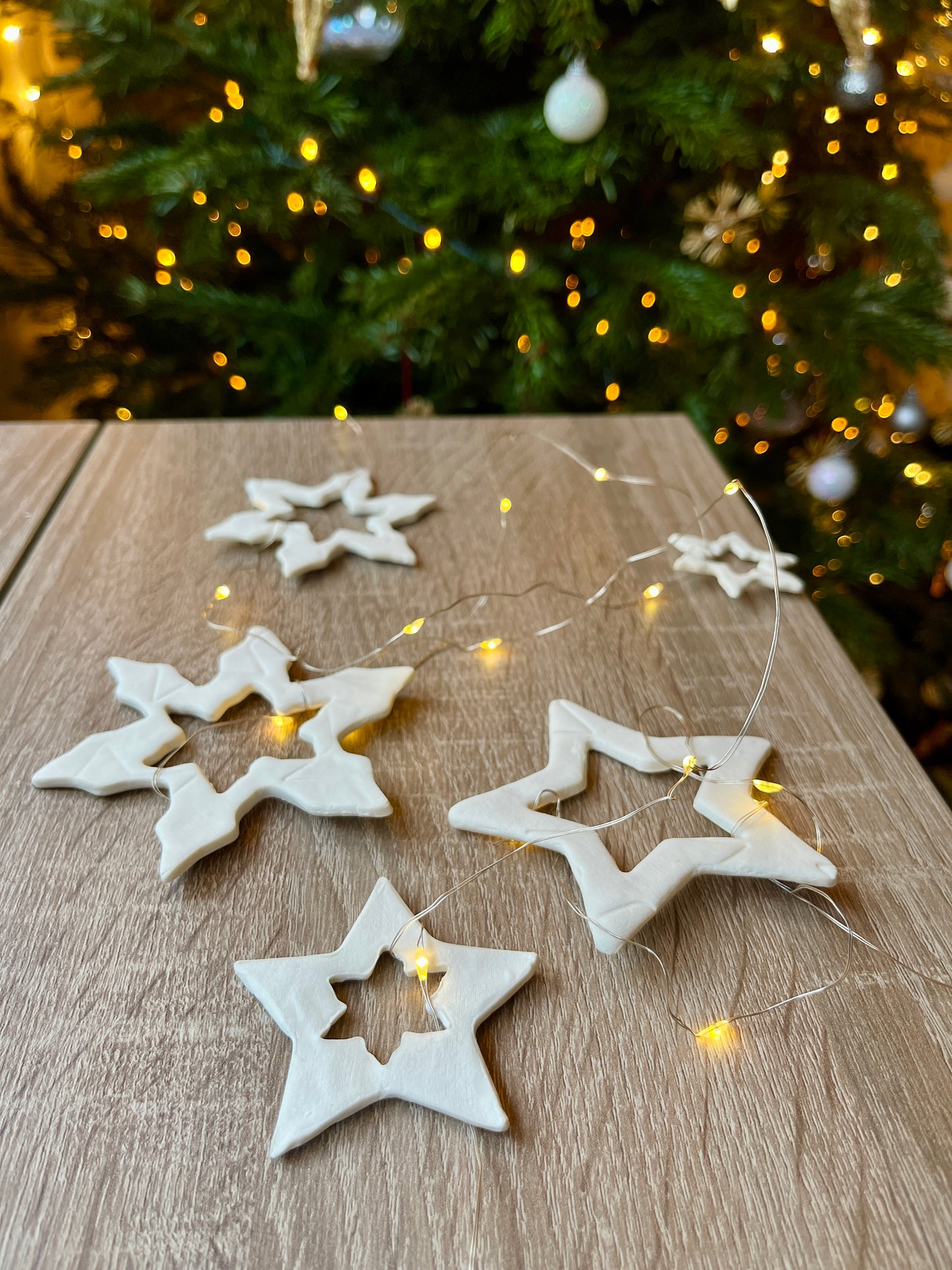 Garland of assorted ceramic porcelain stars with battery powered lights